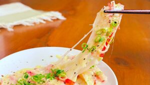 カニカマととろけたチーズを箸で持ち上げたところ