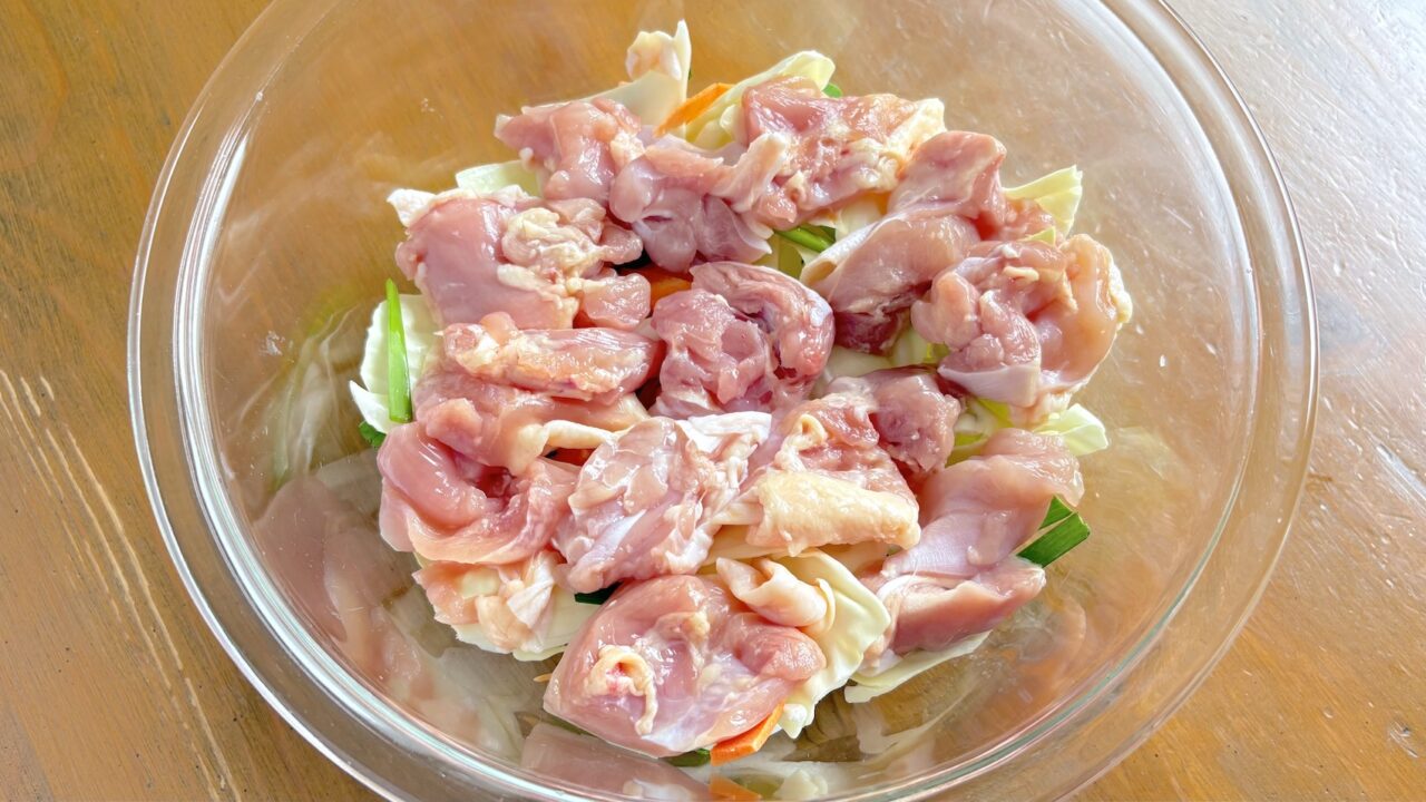 耐熱容器のカット野菜に鶏もも肉をのせたところ