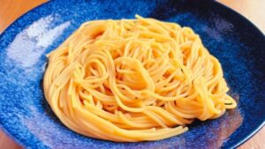 流水で冷やしたパスタを器に盛る